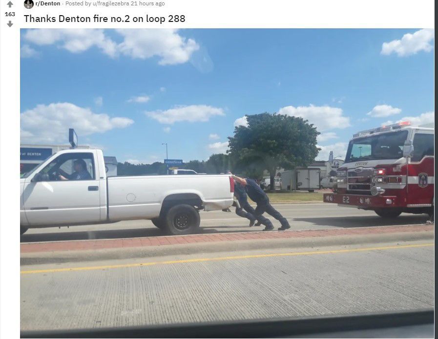 Firefighters pushing truck